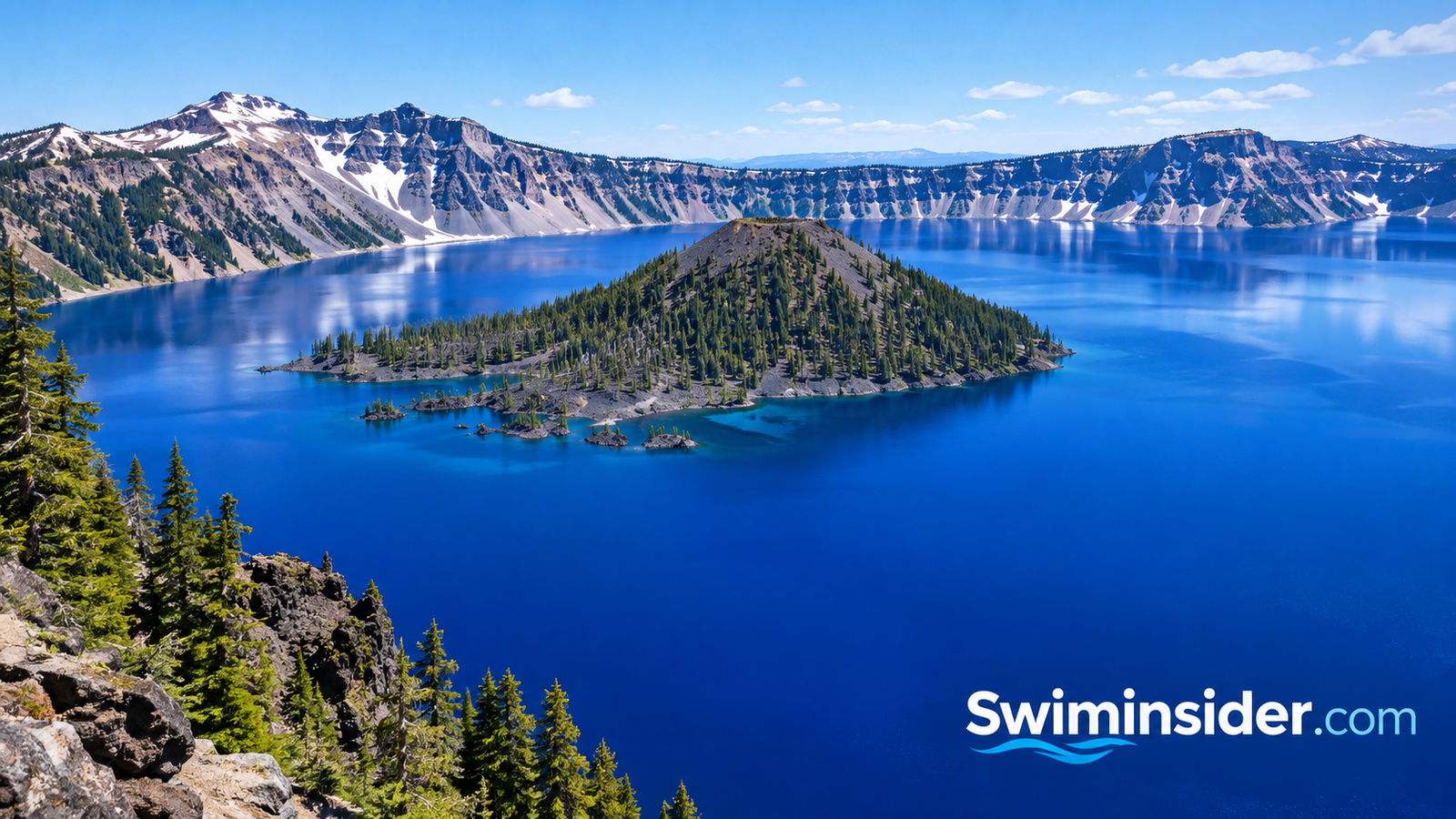 Deep blue water of Crater Lake in Oregon with Wizard Island and the surrounding caldera rim